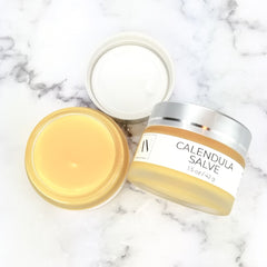 Calendula Herbal Salve, yellow salve in glass jar with silver lid, Adriatic Naturals text visible