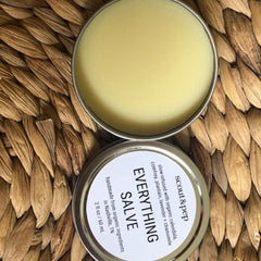 Salve in silver tin with yellow balm and woven background, Scout & Pep brand visible