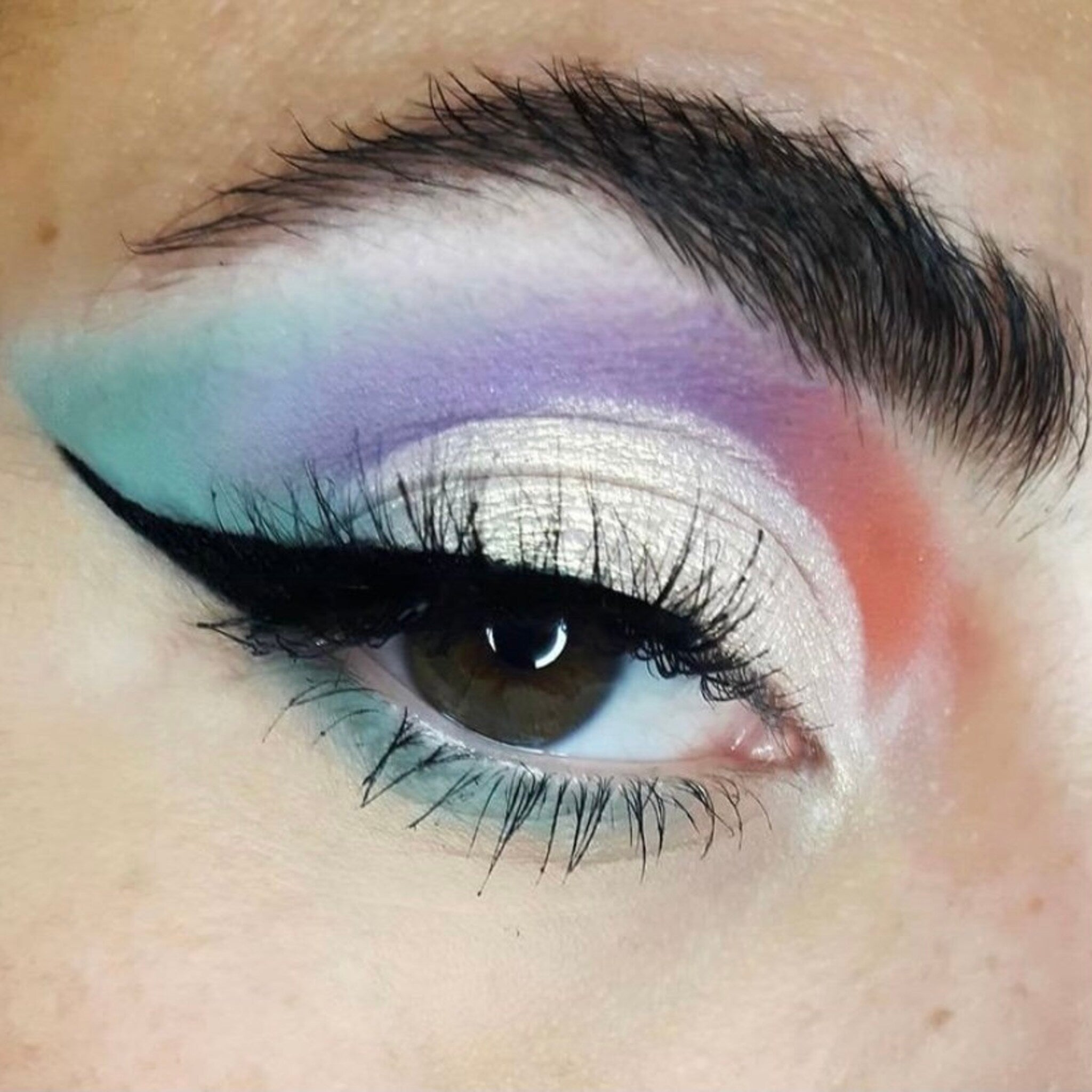 False eyelashes with black mink, eye makeup, and colorful eyeshadow application
