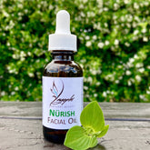 Amber glass dropper bottle of vitamin-rich facial oil with gold cap and minimalist label