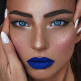 Lip gloss, matte blue lip color on face, with white nail polish on fingers