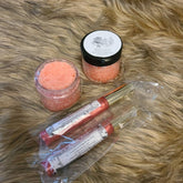 Lip scrub and lip gloss in jars and tubes, orange and pink, Shawzae brand visible