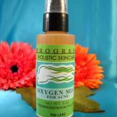 Toner bottle with black cap and green label, "Oxygen Mist" for acne, with flowers in background