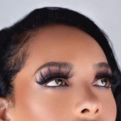False eyelashes with black lashes, brown eyes, and dark eyebrows on a face