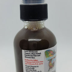 Facial cleanser bottle with black cap, brown liquid, and Holland & Milan label