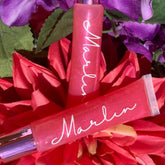 Lip gloss tubes with pink gloss, white script "Marlin", and silver cap