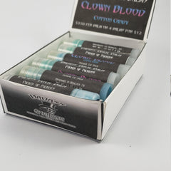 Lip balm tubes in a white box with black labels, blue and silver caps, and "BADASS Apothecary" text