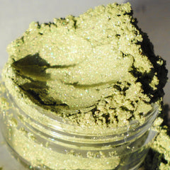 Side view of fresh forest green shimmer eyeshadow pot showing mineral texture and lustrous finish