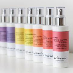 Spray bottles with white and colored labels, silver tops, and "aetherio" brand name visible