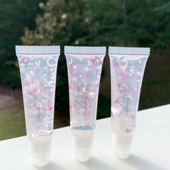 Lip gloss tubes with clear, pink heart accents, and "Purpely Me" branding visible