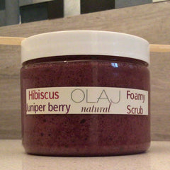 Foamy scrub in a clear jar with white lid, OLAJ label and purple contents