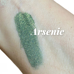 Eyeshadow swatch, green shimmer, textured finish, Crush Arsenic text visible on skin