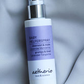 Baby Helper Spray white bottle with purple label and silver top, aetherio brand
