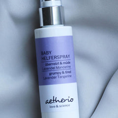 Baby Helper Spray white bottle with purple label and silver top, aetherio brand