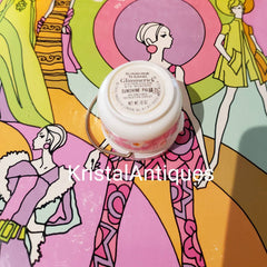 Eye shadow container, white with pink floral pattern, silver handle, "Glimmerick" brand text visible