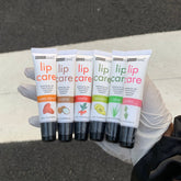 Lip balms, white tubes with colorful text, Beauty Treats lip care products in hand