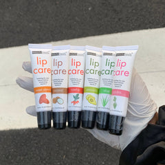 Lip balms, white tubes with colorful text, Beauty Treats lip care products in hand