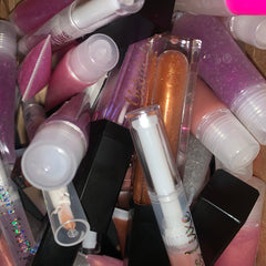 Lip gloss tubes in pink, purple, and clear with LishasLuxe text visible, various colors and textures