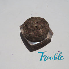 Chocolate brown loose mineral eyeshadow with gold shimmer in a small round jar, vegan and cruelty-free.