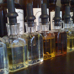 Elegant hand applying golden Vitamin A D E serum onto glowing cheek with dropper bottle in background