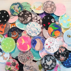 Reusable facial rounds with various patterns and colors, including animal prints and floral designs