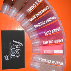 Lip gloss tubes in various colors, clear plastic tubes, Lishas Luxe branding on black card