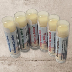 Lip balms in clear tubes with white labels, various flavors and Rock Island Naturals text visible