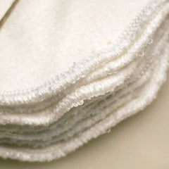 Reusable facial rounds, white cotton with stitched edges, stacked together