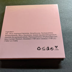 Cosmetics ingredient list on pink paper, with black text and symbols, cruelty-free label visible