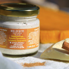 Facial cleanser in glass jar with gold lid, Melofarm label, and cinnamon stick