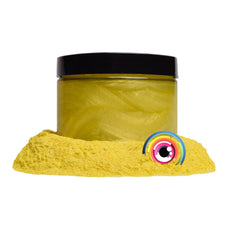 Golden yellow mica pigment powder in a small glass jar with black screw-top lid, shimmering under light