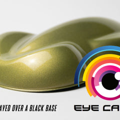 Hand applying golden yellow mica pigment powder to eyelid with fingertip for shimmering eye shadow look