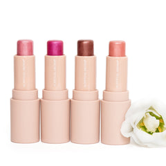 Lipstick tubes in various shades of pink, brown, and peach with "SCENTUAL AROMA" text on the tubes, white flower nearby