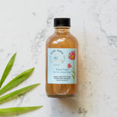 Tea Tree Facial Toner in glass bottle with black cap, Ballerina Botanicals label visible