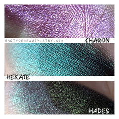 Eyeshadow swatches, Charon purple shimmer, Hekate teal shimmer, Hades green shimmer, Notyce Beauty text