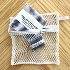 Reusable facial pads with gray and white pattern inside a white mesh bag, DBCDesignedByClaire brand