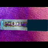 Liquid eyeshadow purple multichrome with POP & POLISHED branding and dark blue cap on purple textured background