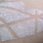 Close-up of Vegan White Wedding Icy Sparkling Eyeshadow pan with frosty white shimmer and delicate glitter particles