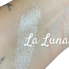 Glitter eyeshadow swatch, iridescent shimmer, applied on skin, La Luna text visible