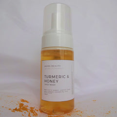 Face wash bottle with clear liquid, white label, and clear plastic cap, Ahima Beauty brand