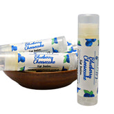 Lip balm tubes with white labels, blue text, and blueberry pattern, BluePoppyBath brand visible