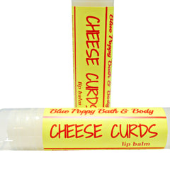 Lip balm with yellow label, red text, and Blue Poppy Bath & Body branding on white background