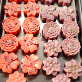 Luxurious golden shea butter lotion bars in a sleek 10-pack, displayed on marble with natural light highlighting their creamy texture