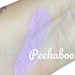 Peekaboo brand swatch of lavender powder on skin, visible texture and brand name