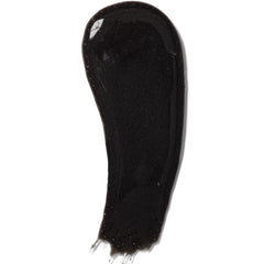 Close-up of black charcoal mask in jar with thick gel texture and matte finish