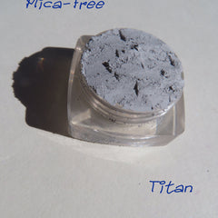 Matte gray loose pigment eyeshadow in a small jar with black lid, vegan mineral makeup with smooth powder texture