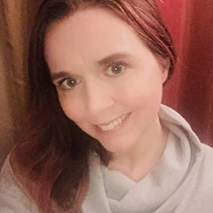 Close-up of four travel-size eyeshadows and blushes in vibrant shades with smooth, blendable textures