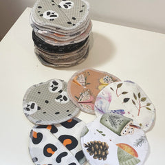 Reusable nursing pads with various patterns and colors, stacked on white surface, Lenas Yard