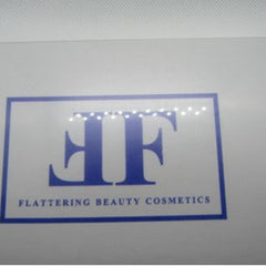 Flattering Beauty Cosmetics logo, blue and white rectangular design with text, brand name visible