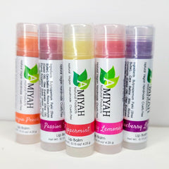 Lip balm bundle with colorful tubes, Amiyah Natural Products branding visible, and clear plastic caps